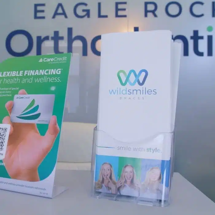Eagle Rock Orthodontics display featuring CareCredit flexible financing brochure and WildSmiles braces information, emphasizing financial support for orthodontic treatment.
