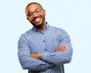Smiling adult man in a checkered shirt, showcasing confidence and satisfaction, representing modern orthodontic options for adults at Eagle Rock Orthodontics.