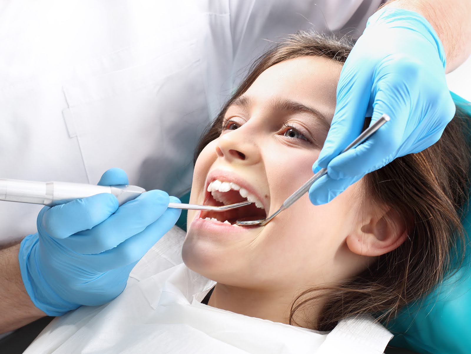 Child receiving a dental exam with early orthodontic treatment in Glendale, being assessed